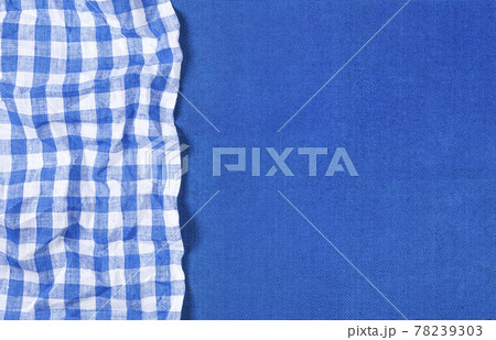 Blue canvas texture with blue checkered napkin, top view 78239303