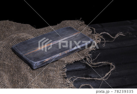 Dark wooden table for product, old black wooden perspective interior with old cutting board 78239335