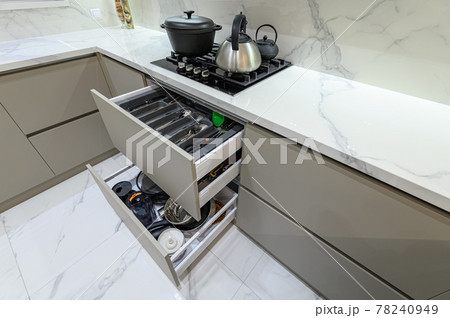 Open drawer with cutlery at modern white woden kitchen in classic style Open drawer with cutlery at modern white woden kitchen in classic style 78240949