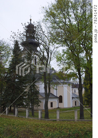 Roman Catholic Church of St. Nicholas, Zamosc. Old catholic church surrounded by autumn trees, landscape. 78241472