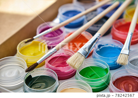 Closeup of messy, used water-color paint-box and paint brush. 78242567