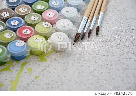 Numbered containers with paints and brushes on canvas 78242576