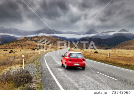 Mountain landscape with red car Mountain landscape with red car 78245060