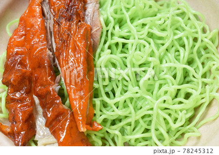 Chinese jade noodles topping slice roasted duck dressing sweet soy sauce picking by chopsticks on bowl Chinese jade noodles topping slice roasted duck dressing sweet soy sauce picking by chopsticks on bowl 78245312