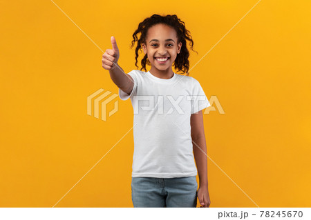 Happy black girl gesturing thumbs up and smiling Happy black girl gesturing thumbs up and smiling 78245670
