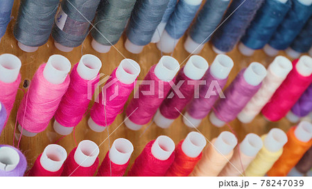 Photo of colourful spools of threads in workshop 78247039