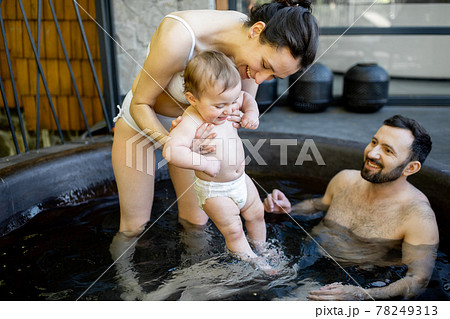 Family at spa with a young baby 78249313