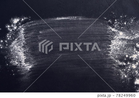 Sprinkled wheat flour. Top view on blackboard. Sprinkled wheat flour. Top view on blackboard. 78249960