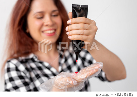 Young woman dyes her hair at home. Bright hair coloring concept. 78250285