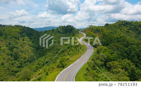 Aerial view of cars driving on curved, zigzag curve road or street on mountain hill with green natural forest trees in rural area of Nan, Thailand. Transportation. 78251193