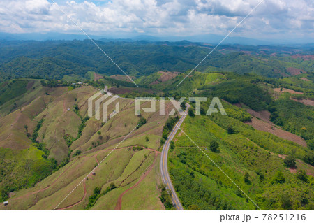 Aerial view of cars driving on curved, zigzag curve road or street on mountain hill with green natural forest trees in rural area of Nan, Thailand. Transportation. Aerial view of cars driving on curved, zigzag curve road or street on mountain hill with green natural forest trees in rural area of Nan, Thailand. Transportation. 78251216