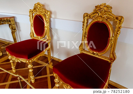 Red classical chairs in a room 78252180