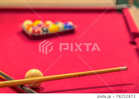 Red billiard table with balls and cue sticks Red billiard table with balls and cue sticks 78252873