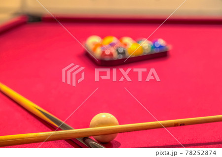 Cue sticks and billiard balls on a red pool table Cue sticks and billiard balls on a red pool table 78252874