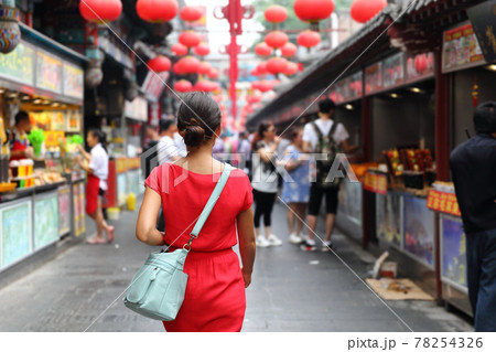 Woman tourist walking in chinatown on china travel. Asian girl on Wangfujing food street during Asia summer vacation. Traditional Beijing snacks being sold at chinese chinatown outdoor market 78254326