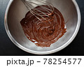 Melting chocolate in pot on dark 78254577