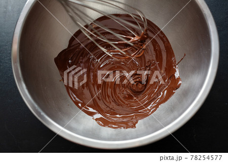 Melting chocolate in pot on dark 78254577