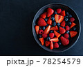 Fresh berries on dark plate on table 78254579