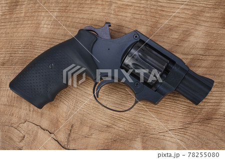 Cocked and locked revolver on wooden table Cocked and locked revolver on wooden table 78255080