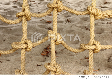 Rope mesh or Rope knot on sand Rope mesh or Rope knot on sand 78257741