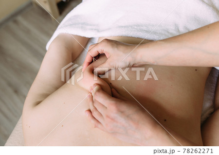 Massage therapist doing massage on the female body in the spa. Massage therapist doing massage on the female body in the spa. 78262271