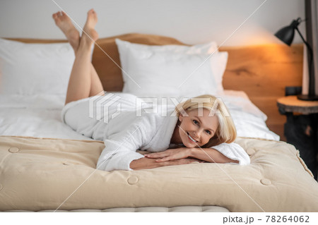 Pretty blonde woman spending time at home and looking contented Pretty blonde woman spending time at home and looking contented 78264062
