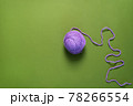 Purple Yarn Ball Thread on green Background. 78266554