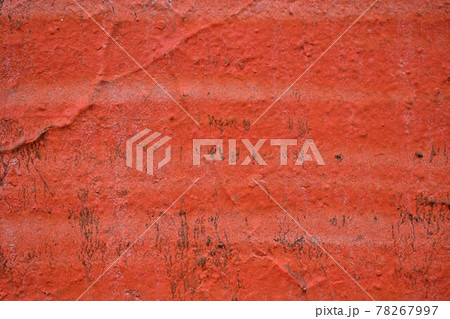 The painted wall of the facade is in bright red. Texture. 78267997