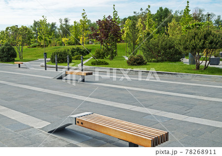 Combined wood and granite benches in city park Combined wood and granite benches in city park 78268911