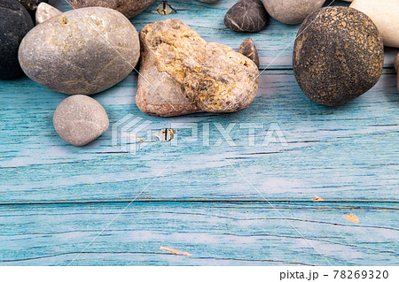 rocks and shells on a blue wooden background.Marine theme rocks and shells on a blue wooden background.Marine theme 78269320