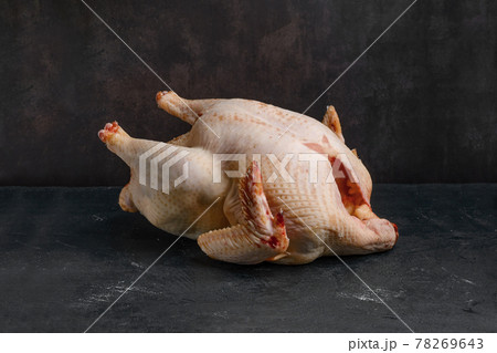Whole raw turkey carcase on dark background. 78269643