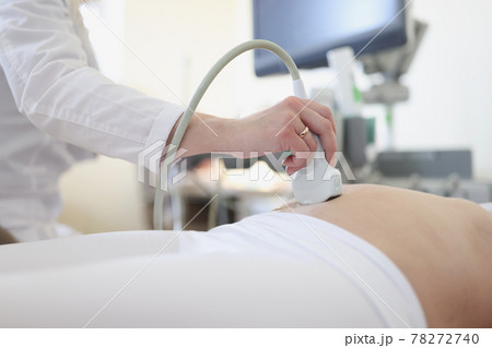 Ultrasound scanner device in hand of professional doctor examining his patient Ultrasound scanner device in hand of professional doctor examining his patient 78272740