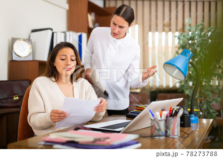 Unhappy woman chief screaming to young female manager 78273788