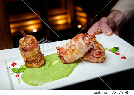 Quail mousse in bacon and broccoli puree. Close-up, selective focus 78275002