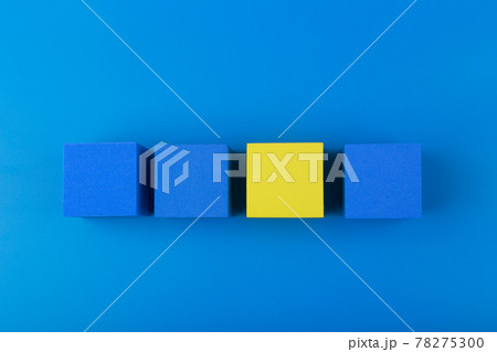 Top view of three blue and one yellow blocks against blue background. Individuality concept Top view of three blue and one yellow blocks against blue background. Individuality concept 78275300