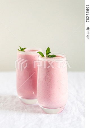 Two glasses of strawberry milkshake. Two glasses of strawberry milkshake. 78276691