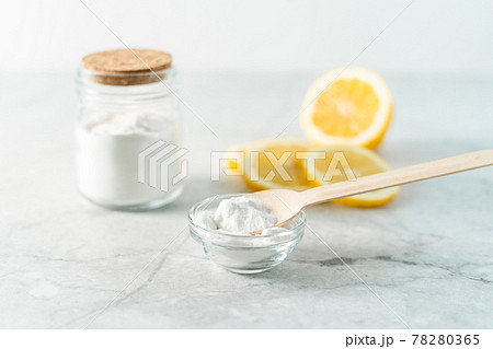 Eco friendly natural cleaners, jar with baking soda, lemon and wooden spoon on marble table background. Organic ingredients for homemade cleaning. Zero waste concept 78280365