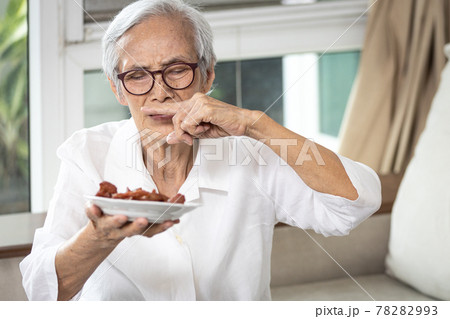 Senior woman holding plate of bad spoiled or expired food in her hand,rotten food,emitting a fetid smell or strong-smelling food,disgusted old elderly cover nose with her finger,diet,nutrition concept Senior woman holding plate of bad spoiled or expired food in her hand,rotten food,emitting a fetid smell or strong-smelling food,disgusted old elderly cover nose with her finger,diet,nutrition concept 78282993