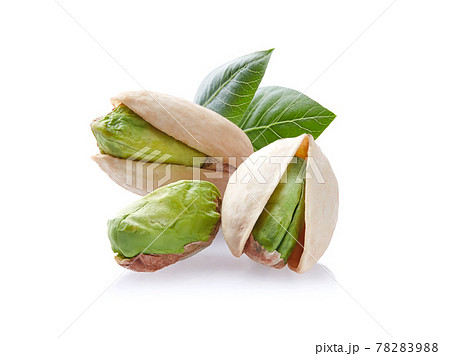 Pistachio with leaves in closeup on white background 78283988