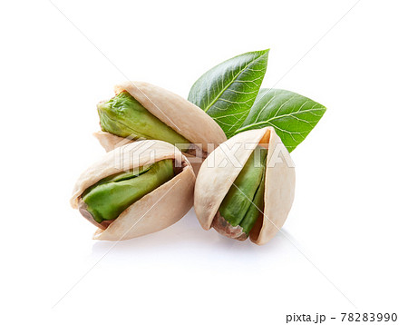 Pistachio with leaves in closeup on white background 78283990