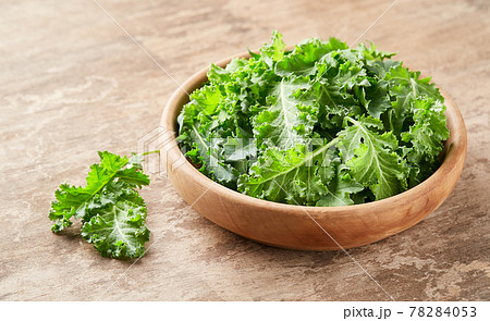 Kale leaves vegetable on wooden background Kale leaves vegetable on wooden background 78284053
