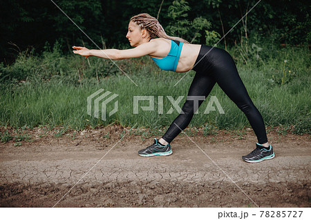 Outdoor sports. Fit woman warming up exercising 78285727