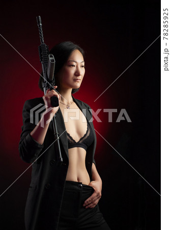 asian woman in a jacket with an automatic rifle in her hands mafia fighter asian woman in a jacket with an automatic rifle in her hands mafia fighter 78285925