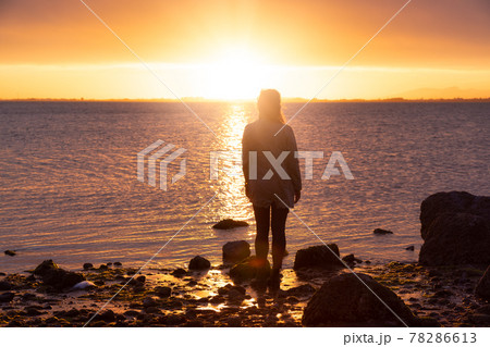 Adventure Caucasian Adult Woman Standing on a rocky beach Adventure Caucasian Adult Woman Standing on a rocky beach 78286613