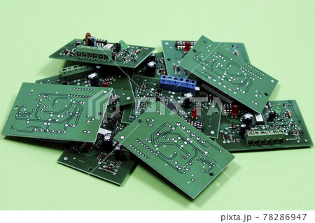 Electronic printed circuit boards on a green background. Recycling of electronic waste 78286947