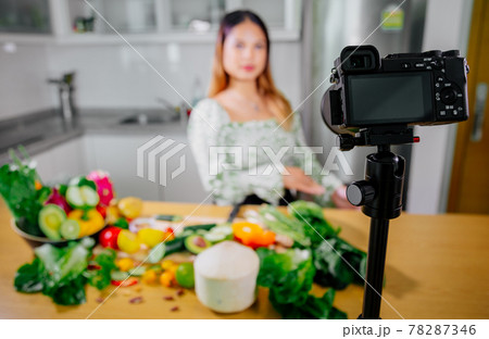 Asian woman blogger or content creator cooking and recording video camera. showing healthy food 78287346