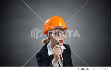 Technical inspector looking through magnifier 78288062