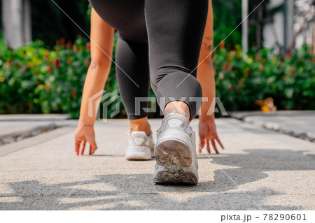 Asian sport girl doing stretching, yoga fitness and plank exercise outside. Fit young thai woman Asian sport girl doing stretching, yoga fitness and plank exercise outside. Fit young thai woman 78290601