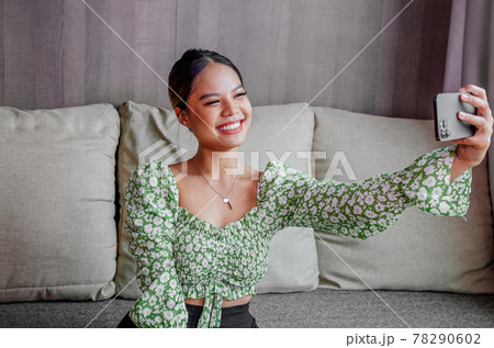 Pretty asian girl take a self portrait with her smart phone. Thai girl selfie. Pretty asian girl take a self portrait with her smart phone. Thai girl selfie. 78290602