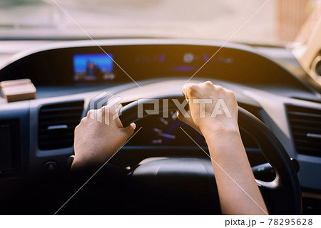 Hands woman holding steering wheel,Driving a car on road Hands woman holding steering wheel,Driving a car on road 78295628